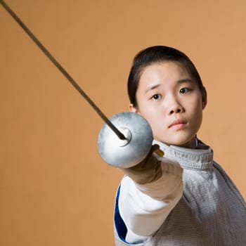 Portrait of a female fencer fencing