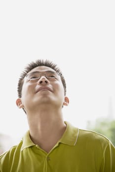 Close-up of a young man looking up
