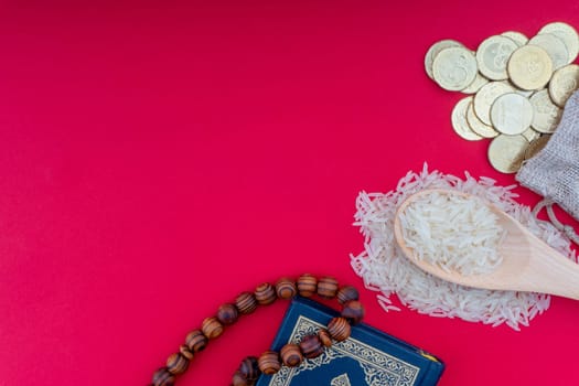 Holy Quran , Coins, Rosary and rice. Zakat concept. Zakat is a form of alm-giving as a religious obligation