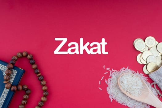 ZAKAT words with Holy Quran, Coins, Rosary and Rice. Zakat concept. Zakat is a form of alm-giving as a religious obligation