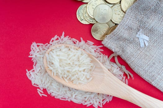 Coins and rice on red background. Zakat concept. Zakat is a form of alm-giving as a religious obligation