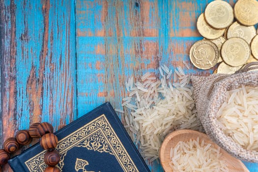 Holy Quran, Coins, Rosary and Rice. Zakat concept. Zakat is a form of alm-giving as a religious obligation
