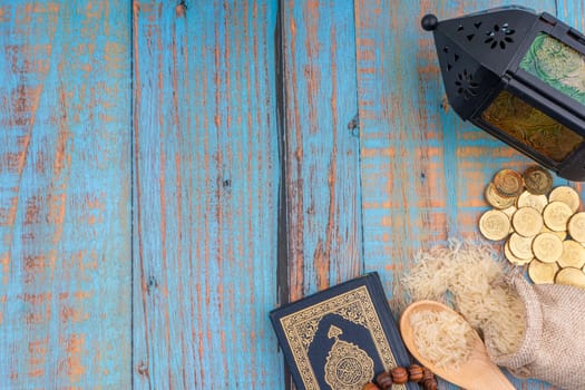 Holy Quran with arabic calligraphies translation meaning of Al-Quran, Coins, Rosary and Rice. Zakat concept. Zakat is a form of alm-giving as a religious obligation