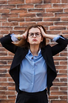 tired young woman in suit keeps her head.