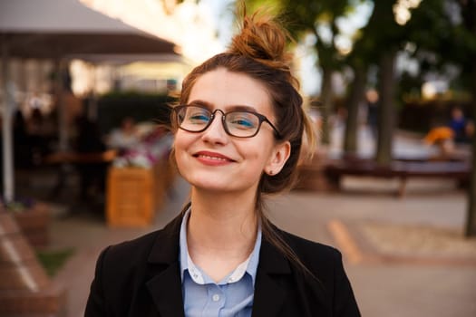 Business woman in suit portrait during travel for company meeting outdoor brunette with glasses