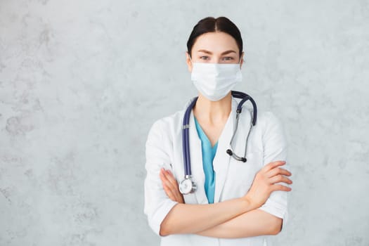 Young female doctor with stethoscope in mask. caucasian brunette