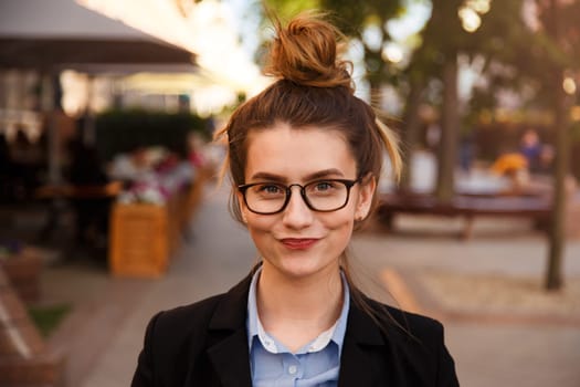 Young caucasian businesswoman in glasses smiling pursed lips