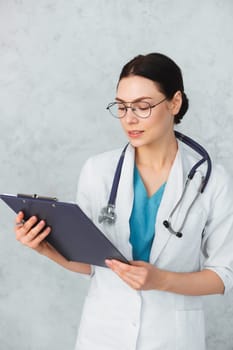 Young female doctor with stethoscope and folder. caucasian brunette.
