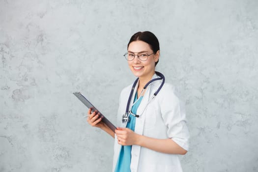 Young female doctor with stethoscope and folder. caucasian brunette.