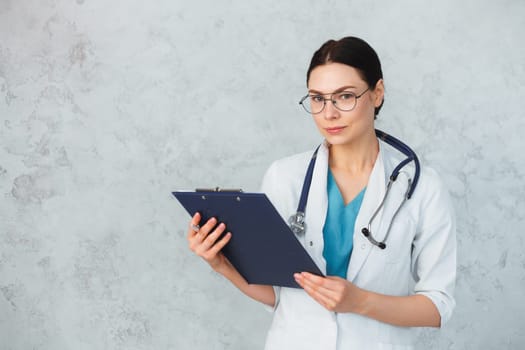 Young female doctor with stethoscope and folder. caucasian brunette.