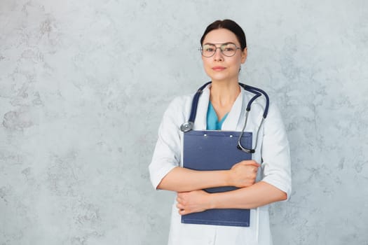 Young female doctor with stethoscope and folder. caucasian brunette.