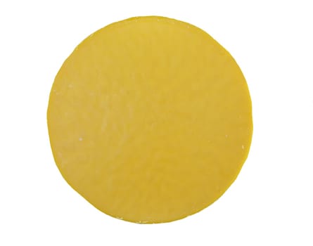 Round yellow wax block isolated