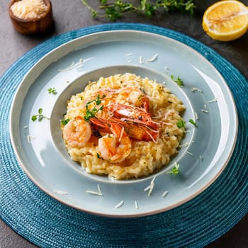 Risotto aux gambas features creamy Arborio rice topped with grilled prawns and garnished with colorful accents for an indulgent experience.