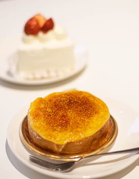 Creme Brulee Roll Cake and strawberry cake blur background. Food and beverage dessert café business.