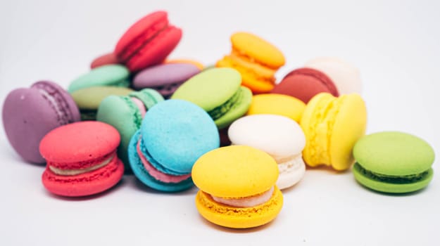 Pastel colored macarons sweet French dessert isolated on white background.