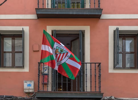 House facade with flag Athletic Bilbao in the old town of Bilbao, Spain