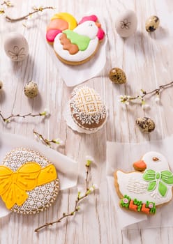 Easter decoration with homemade Easter gingerbread cookies on wooden table