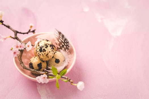 Easter eggs on with cherry branch in pink tone. Easter decoration in vintage style with copy space