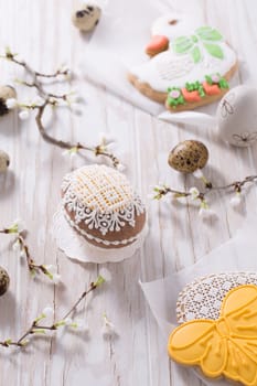Easter decoration with homemade Easter gingerbread cookies on wooden table