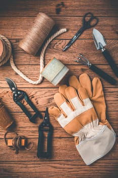 Gardening tools and equipment on wooden background