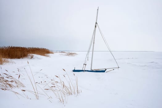 Frozen and snowed-in sailing boat on the Saaler Bodden, Fischland-Darß
