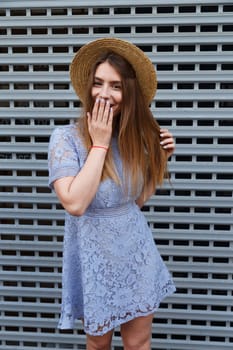 beautiful woman closing her mouth by hand while laughing