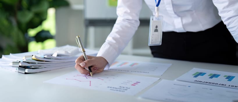 An accountant writes financial strategies on paper, showcasing analytical skills and a professional approach to finance.