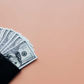 Bundle of dollars in purse on beige background. High quality photo