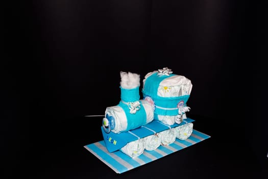 HEILIGENHAUS, NRW, GERMANY - JANUARY 21, 2019:.Diaper cake. A nappy pie locomotive with blue ribbons. Gift for the birth of a child