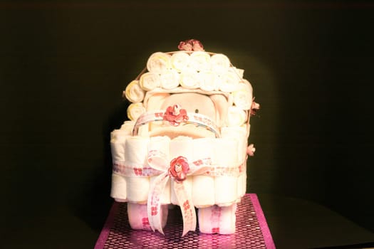 HEILIGENHAUS, NRW, GERMANY - JANUARY 16, 2019:.Newborn gift concept. Cake of diapers. Packed diapers as a stroller