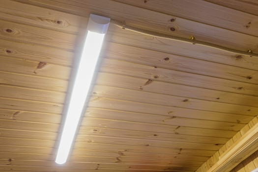 Included daylight lamp on wood paneling ceiling