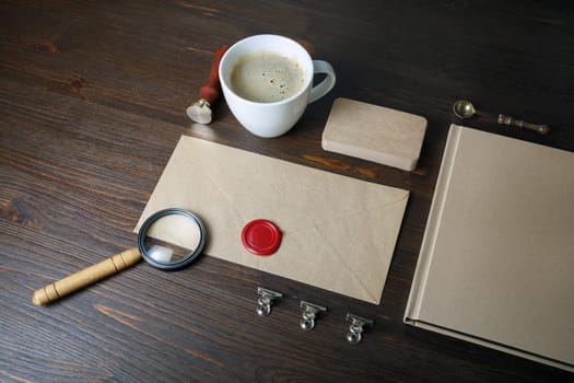 Photo of blank vintage stationery elements on wood table background. Responsive design mockup. ID template.