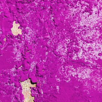 Old bright pink grunge material. Peeling paint and rust stains.