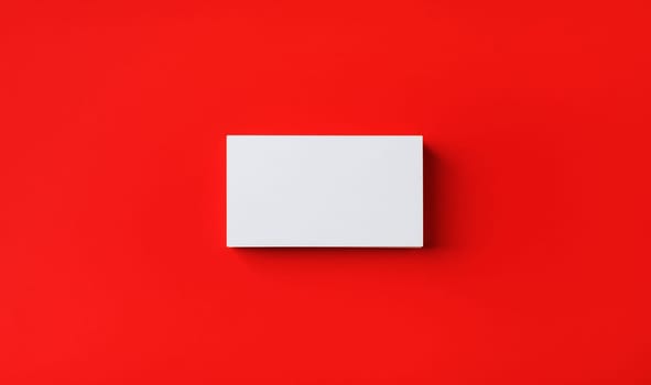 Photo of blank business card on red paper background. Template for branding identity. Mockup for ID. Flat lay.