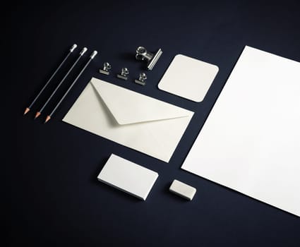 Blank corporate stationery set on black paper background. Corporate identity template. Responsive design mockup.