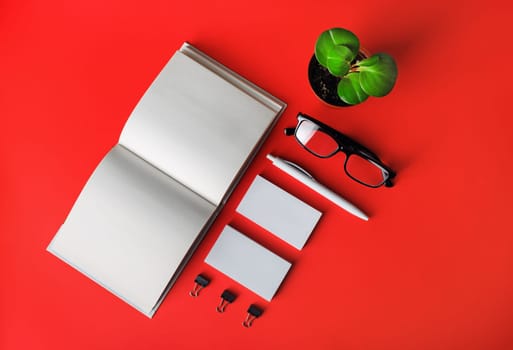 Blank stationery set on red paper background. Template for branding identity. For graphic designers presentations and portfolios. Flat lay.