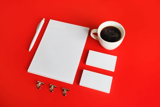 Blank corporate identity template on red paper background. Photo of blank stationery set. Mockup for design presentations and portfolios.