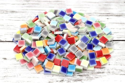 stacked of colorful tiles on white wooden table