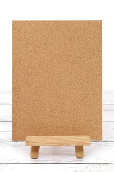 Wooden easel and blank board on a white wooden table