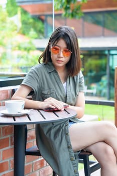 Pretty woman sitting in a cafe terrace with coffee cup