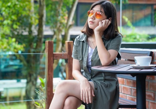 Pretty woman sitting in a cafe terrace with coffee cup