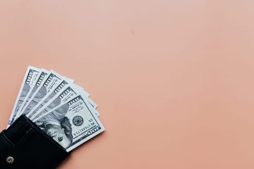Bundle of dollars in purse on beige background. High quality photo