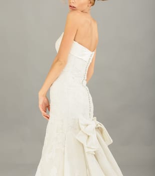 Beautiful bride on grey background. Studio shot
