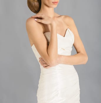 Beautiful bride on grey background. Studio shot