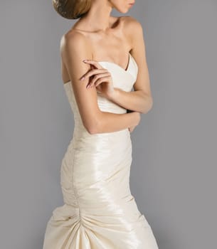 Beautiful bride on grey background. Studio shot