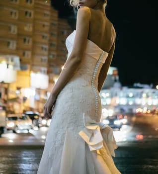 Beautiful bride on street in the night. Street fashion