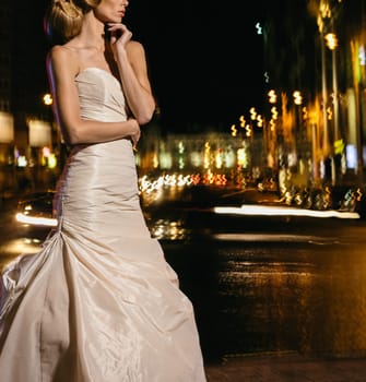 Beautiful bride on street in the night. Street fashion