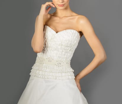 Beautiful bride on grey background. Studio shot
