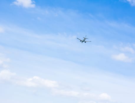 A plane goes away in the sky.