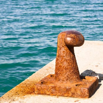 Rusty bollard for mooring boats .